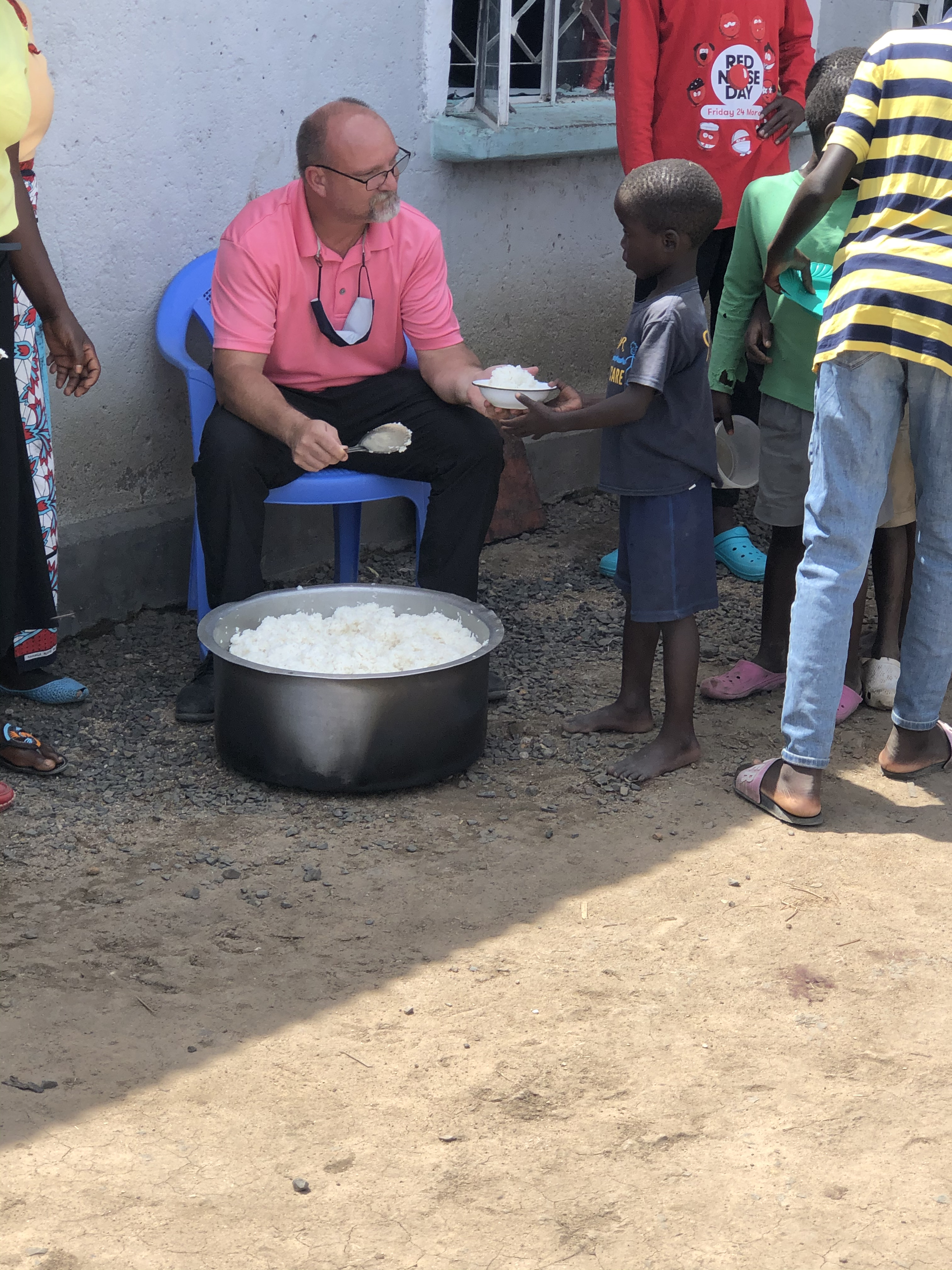 Pastor Micheal feeding the children