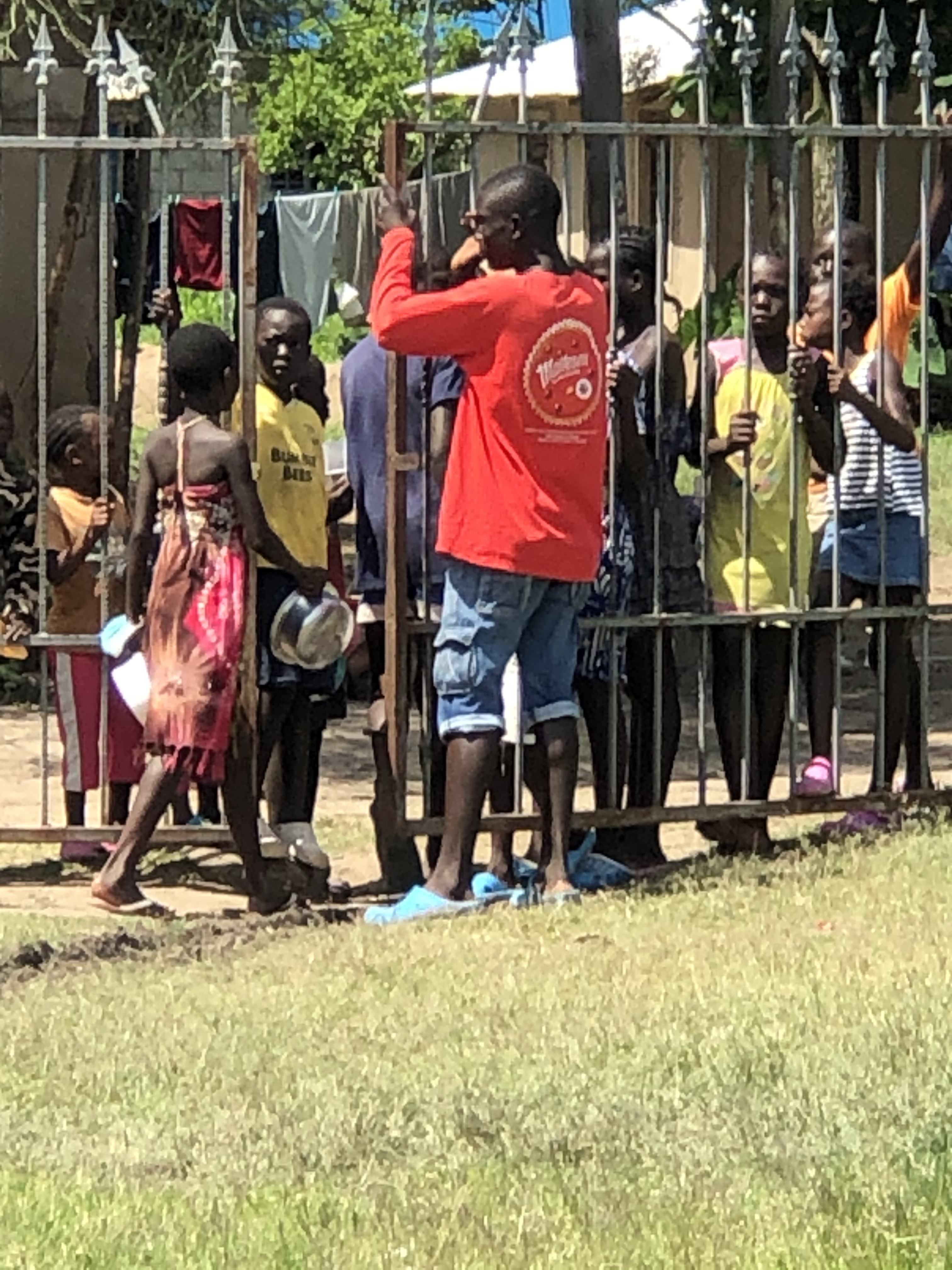 The local children outside the orphanage waiting to be let in to get their portion.  The orphanage feeds not only their 40 children but about 200 more from the local village.