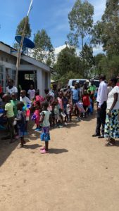 The children lined up to eat.  They bring their own containers.