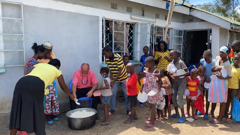 Pastor Micheal feeding the children.