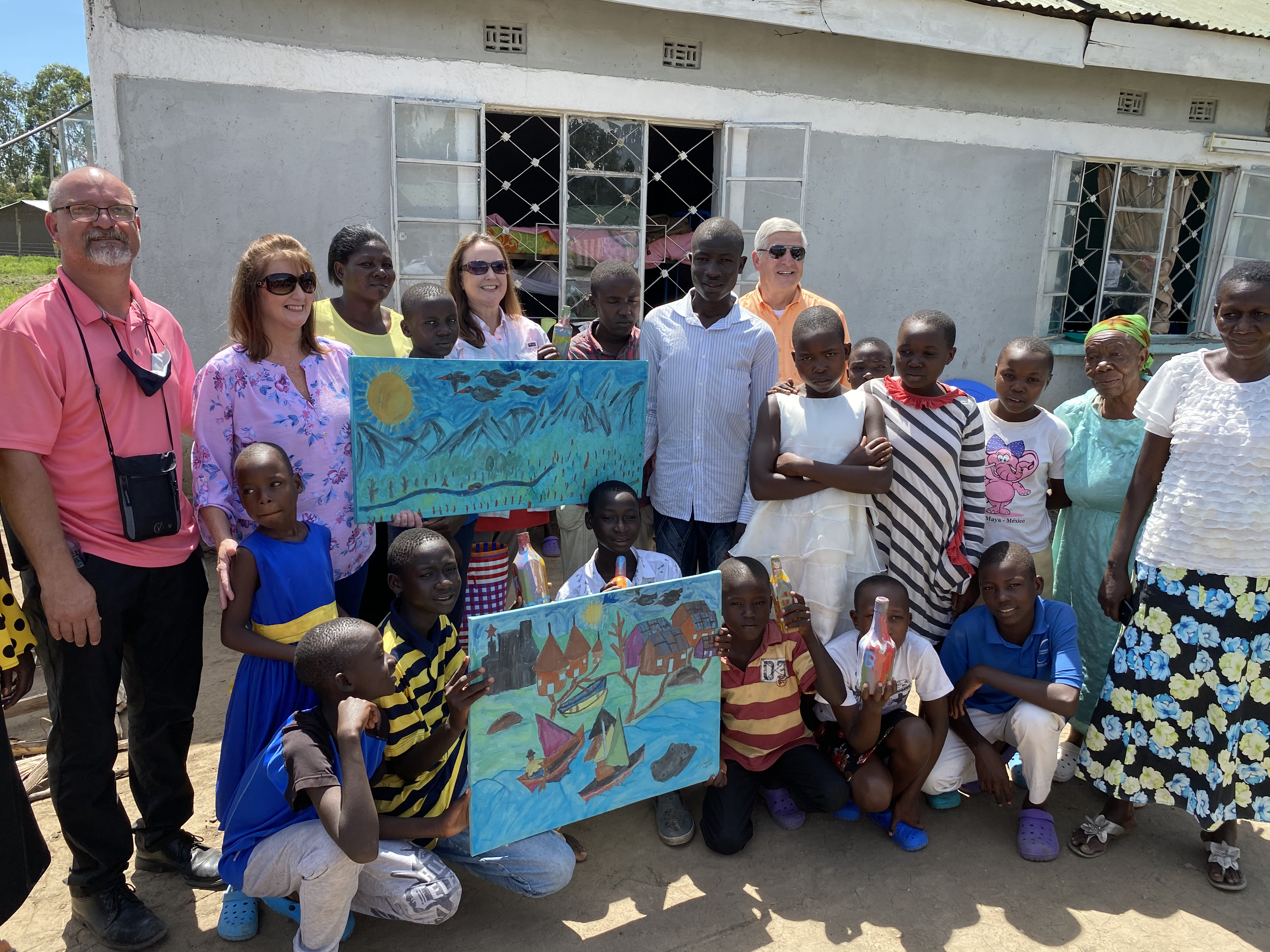 The talented artists showing off their work at the orphanage.