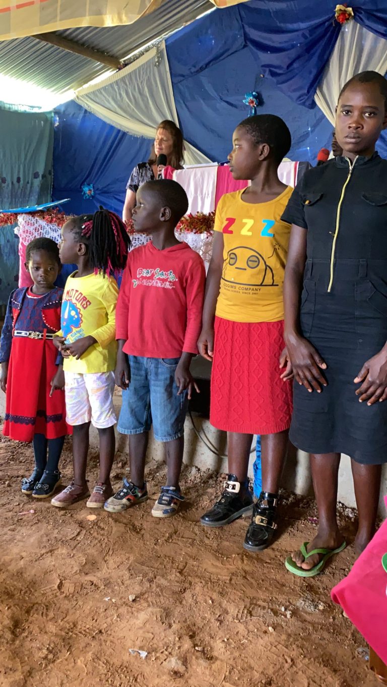 The children line up across the front to represent the stages of the life of Christ