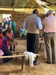 Apostle John- if you look in the back, you will see the local children have gathered around the door to listen--and to get a closer look at a "Mzungu"