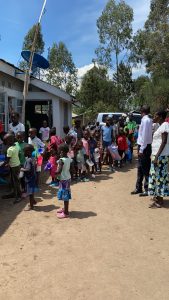 The children lined up to eat.  They bring their own containers.